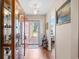 Cozy foyer boasts wood floors, a display cabinet, and natural light at 6478 Royal Pine Dr., Myrtle Beach, SC 29588