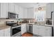 This kitchen features white cabinets and stainless steel appliances and faucet at 6478 Royal Pine Dr., Myrtle Beach, SC 29588