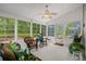 Bright sunroom with white walls, a ceiling fan, and a variety of comfortable seating options at 6478 Royal Pine Dr., Myrtle Beach, SC 29588