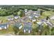 An aerial view shows white condos with green roofs in a lush, landscaped community with a pool and pond at 664 Tupelo Ln. # 8A, Longs, SC 29568
