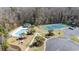 Aerial view of community pool and tennis court with surrounding trees at 664 Tupelo Ln. # 8A, Longs, SC 29568