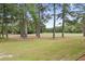 Lush green backyard with mature trees and a view of the open golf course at 664 Tupelo Ln. # 8A, Longs, SC 29568
