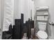 Clean bathroom featuring a city themed shower curtain and storage shelves at 664 Tupelo Ln. # 8A, Longs, SC 29568