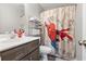 Cozy bathroom with a sink, a decorative Spiderman shower curtain, and shelf storage at 664 Tupelo Ln. # 8A, Longs, SC 29568