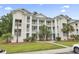 Inviting three-story condo building featuring private balconies, palm trees, and well-maintained landscaping at 664 Tupelo Ln. # 8A, Longs, SC 29568