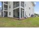 Exterior view of a multi-story home with screened porches and green lawn at 664 Tupelo Ln. # 8A, Longs, SC 29568