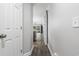 Neutral-toned hallway with wood floors leading to living area with sliding barn door and lots of natural light at 664 Tupelo Ln. # 8A, Longs, SC 29568