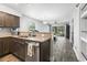 Bright kitchen with stainless steel appliances and an opening to a living room with wooded views at 664 Tupelo Ln. # 8A, Longs, SC 29568