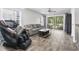 Bright living room with sliding glass doors to an outdoor patio and modern furniture and wood flooring at 664 Tupelo Ln. # 8A, Longs, SC 29568