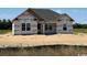 New construction home featuring a modern design and bright, unfinished exterior at 6696 Joyner Swamp Rd., Galivants Ferry, SC 29544