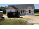 New construction home featuring a gray roof, white trim, and a spacious lot, ready for personalization at 6704 Joyner Swamp Rd., Galivants Ferry, SC 29544