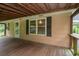 View of the covered wooden back porch with a backyard view at 704 N North Congdon St., Georgetown, SC 29440