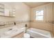 Bathroom with vintage fixtures featuring a vanity, toilet, and bathtub near a window at 704 N North Congdon St., Georgetown, SC 29440