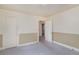 Bedroom featuring a chair rail, door, and neutral colored carpet at 704 N North Congdon St., Georgetown, SC 29440