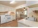 Shows the kitchen and dining area with white appliances, cabinetry, and wood-look floors at 704 N North Congdon St., Georgetown, SC 29440