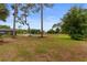 Large backyard with mature trees and view of a pond with a fountain at 7253 Seville Dr., Myrtle Beach, SC 29572