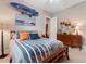 Stylish bedroom showcasing unique surf decor, complemented by a wooden dresser at 7253 Seville Dr., Myrtle Beach, SC 29572