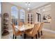 The formal dining room showcases arched windows, a marble table, and a stylish curio cabinet at 7253 Seville Dr., Myrtle Beach, SC 29572