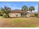 Beautiful home exterior featuring a tile roof, mature trees, and a lush yard at 7253 Seville Dr., Myrtle Beach, SC 29572