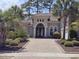 Charming home with a tile roof, manicured landscaping, and a brick driveway at 7253 Seville Dr., Myrtle Beach, SC 29572