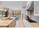 Open kitchen features granite countertops, stainless appliances, island with bar seating, and adjacent breakfast nook at 7253 Seville Dr., Myrtle Beach, SC 29572