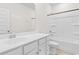 Well-lit bathroom featuring a spacious vanity with white cabinets and a tub with shower at 739 Harrison Mill St., Myrtle Beach, SC 29579