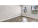 Bedroom with natural light coming in from two windows and wood-look flooring at 739 Harrison Mill St., Myrtle Beach, SC 29579