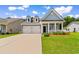 Charming light blue home boasts a two-car garage, inviting front porch, and manicured lawn at 739 Harrison Mill St., Myrtle Beach, SC 29579