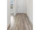 Hallway view features light wood floors, white trim, and a white entry door at 739 Harrison Mill St., Myrtle Beach, SC 29579