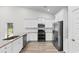 Bright kitchen features stainless steel appliances, white cabinets, and granite countertops at 739 Harrison Mill St., Myrtle Beach, SC 29579