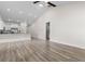 Open concept living space with high ceilings, modern wood flooring, and kitchen with stainless appliances at 739 Harrison Mill St., Myrtle Beach, SC 29579