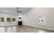 The living room has lots of natural light, a ceiling fan, fireplace, and wood flooring at 739 Harrison Mill St., Myrtle Beach, SC 29579