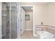 Inviting bathroom featuring a bathtub with a shower and an adjacent glass door shower stall at 8121 Amalfi Pl. # 7-604, Myrtle Beach, SC 29572