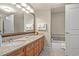 Well-lit bathroom with double vanity, granite countertop, mirror, and a bathtub with tiled backsplash at 8121 Amalfi Pl. # 7-604, Myrtle Beach, SC 29572