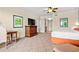 Bright bedroom with comfortable bed, TV, desk, and hallway and bathroom entrance access at 8121 Amalfi Pl. # 7-604, Myrtle Beach, SC 29572