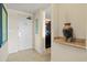 Inviting hallway with neutral tones, tiled floor, and stylish vase detail, leading to the kitchen area at 8121 Amalfi Pl. # 7-604, Myrtle Beach, SC 29572