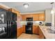 Modern kitchen featuring wooden cabinetry, granite countertops, and black appliances perfect for culinary enthusiasts at 8121 Amalfi Pl. # 7-604, Myrtle Beach, SC 29572