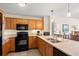 Well-equipped kitchen with wooden cabinets, stainless steel appliances, and a functional layout for cooking at 8121 Amalfi Pl. # 7-604, Myrtle Beach, SC 29572