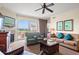 Cozy living area with comfortable seating, fireplace, and balcony access offering scenic views of the surrounding landscape at 8121 Amalfi Pl. # 7-604, Myrtle Beach, SC 29572