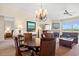 Living room with dining table, fireplace, and balcony access offering bright natural light and cozy ambiance at 8121 Amalfi Pl. # 7-604, Myrtle Beach, SC 29572