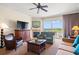 Inviting living room featuring plush seating, a fireplace, a flat-screen TV, and a picturesque balcony view at 8121 Amalfi Pl. # 7-604, Myrtle Beach, SC 29572