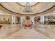The luxurious hotel lobby offers marble floors, soaring ceilings, a chandelier, and comfortable seating at 8121 Amalfi Pl. # 7-604, Myrtle Beach, SC 29572