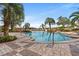 Beautiful outdoor pool surrounded by lounge chairs, palm trees, and lush landscaping at 8121 Amalfi Pl. # 7-604, Myrtle Beach, SC 29572