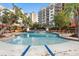 Beautiful pool at Marina Inn features lounge chairs and palm trees for relaxing by the water at 8121 Amalfi Pl. # 7-604, Myrtle Beach, SC 29572