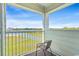 Balcony view with a chair and a vista of water and greenery, perfect for relaxation at 9400 Shore Dr. # 507, Myrtle Beach, SC 29572