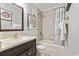 Bathroom features a tub-shower, vanity with granite counter, mirror, and tiled walls at 9400 Shore Dr. # 507, Myrtle Beach, SC 29572