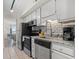 Kitchen equipped with stainless steel appliances, white cabinets, and tile backsplash at 9400 Shore Dr. # 507, Myrtle Beach, SC 29572