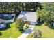 Aerial shot of the home with a metal roof, fenced backyard, and mature trees at 9664 Middleton Ct., Murrells Inlet, SC 29576