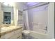 Bathroom featuring a combination tub and shower, a sink with storage space, and a mirrored medicine cabinet at 9664 Middleton Ct., Murrells Inlet, SC 29576