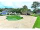 Community pool and pool house surrounded by a deck and green space at 9664 Middleton Ct., Murrells Inlet, SC 29576